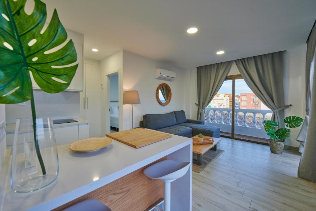 a kitchen and living room with a couch and a table at ABLANCAS - La Restinga in La Restinga