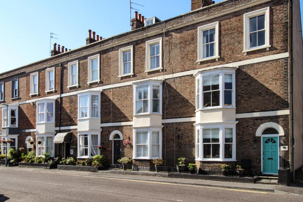 a row of brick houses on a street at Seaside House in Weymouth