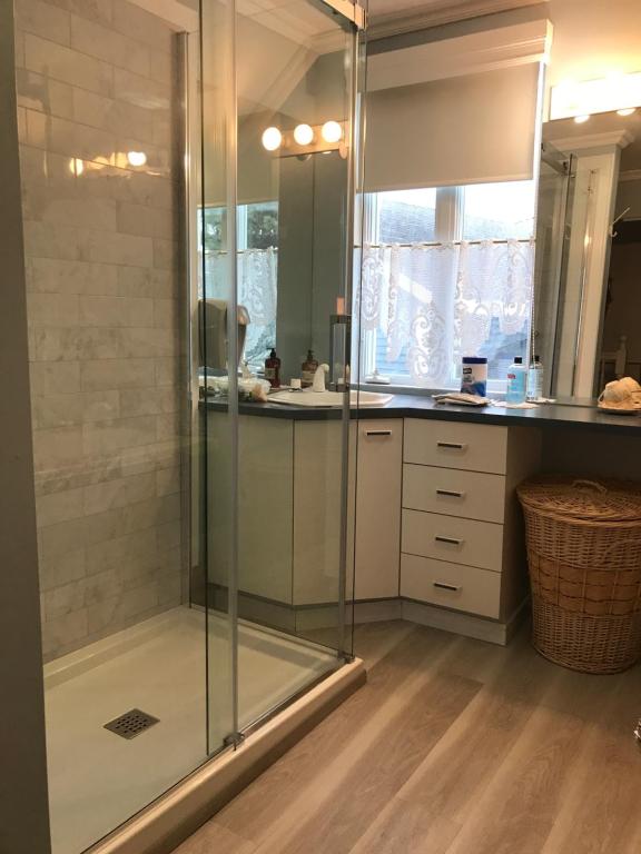 a shower with a glass door in a bathroom at gite des iles in Matane