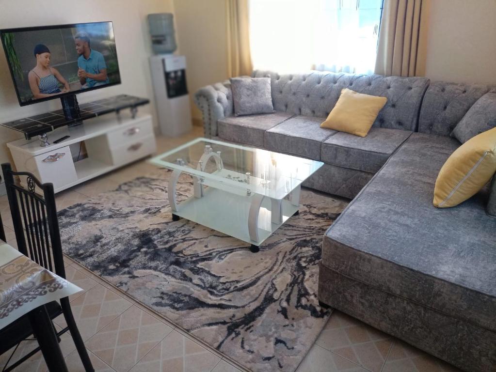 a living room with a couch and a coffee table at Cozy Apartment - Nyali Mombasa in Mombasa