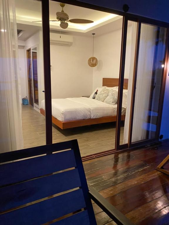Postel nebo postele na pokoji v ubytování Woody's Place Siargao