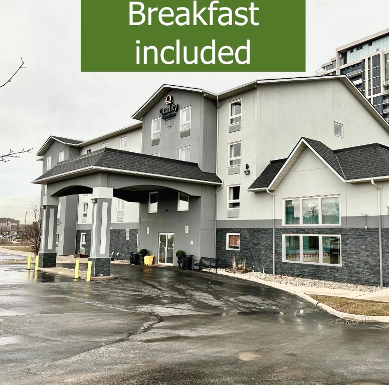 a building with the words breakfast included in front of it at Quality Inn & Suites in Grimsby