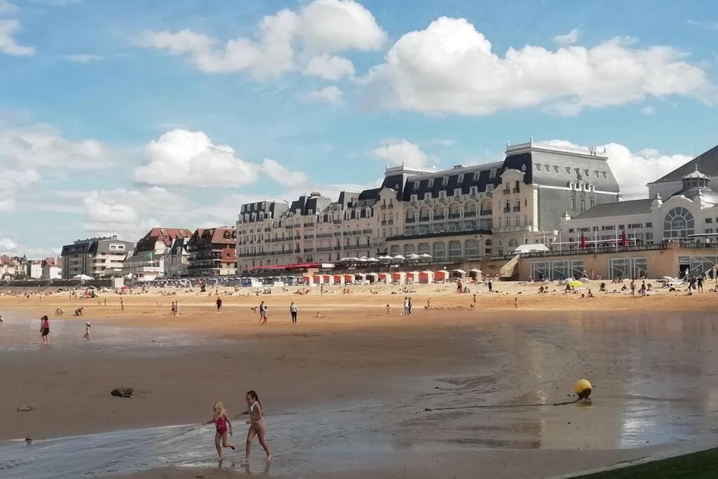 a group of people walking on the beach at 2 pièces ensoleillé accès direct plage in Cabourg