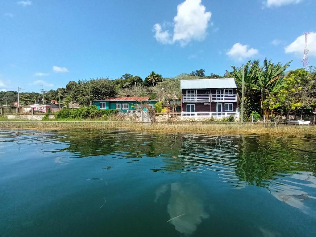 a house on the shore of a body of water at Posada Don Julio in Flores