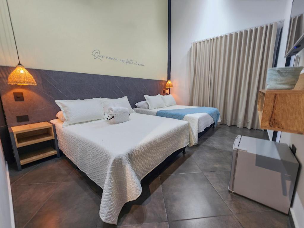 Cette chambre comprend 2 lits et une télévision. dans l'établissement Hotel Capri Doradal, à Doradal