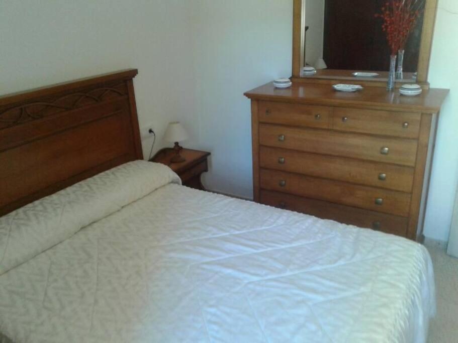 a bedroom with a bed and a dresser at relax apartamento in Son Carrio