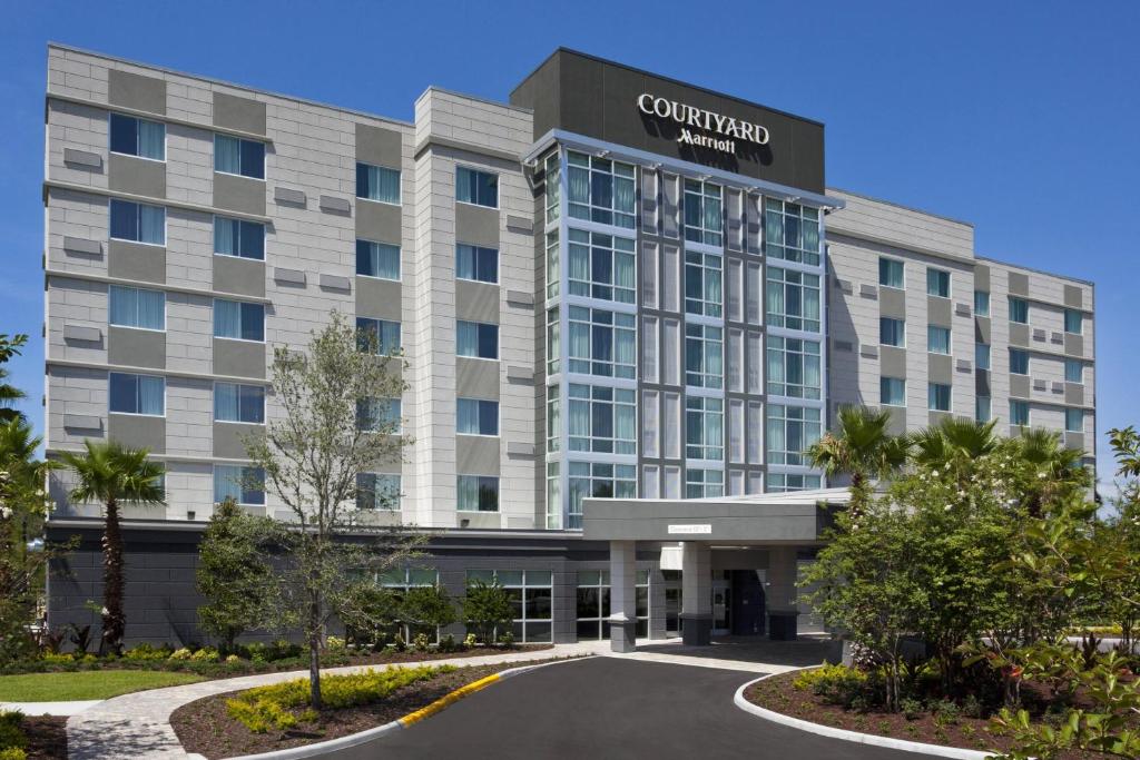 a rendering of the exterior of a convention center hotel at Courtyard by Marriott Orlando South/Grande Lakes Area in Orlando