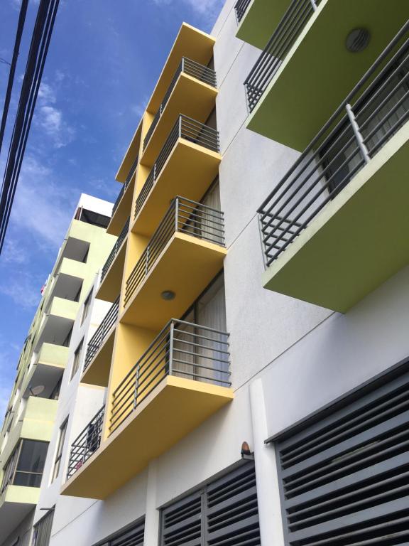 an apartment building with yellow balconies on it at Departamentos RO in Antofagasta