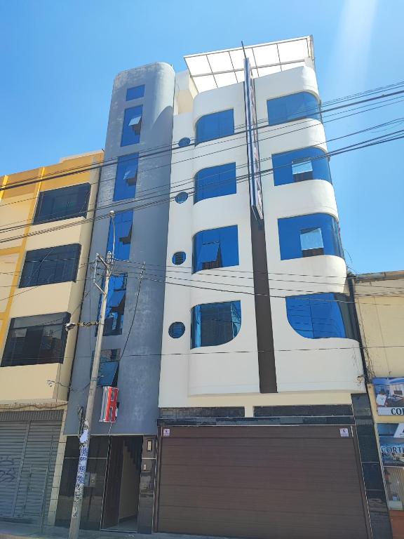 a building with a garage in front of it at HOSTAL SAMAYWASI in Huancayo