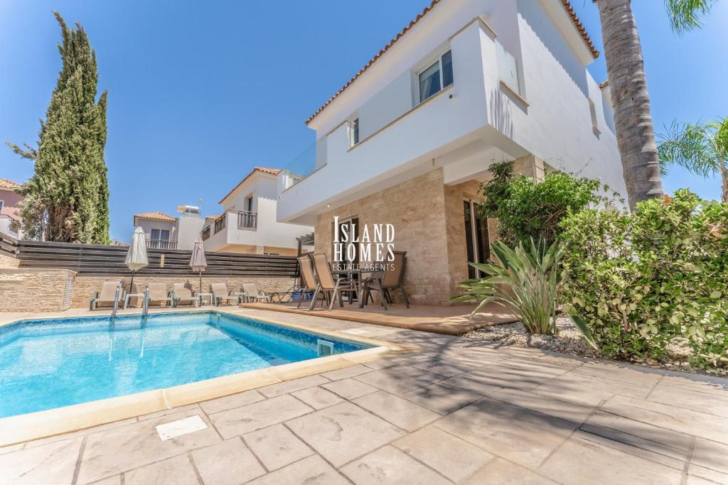 a villa with a swimming pool and a house at Villa Joia in Ayia Napa