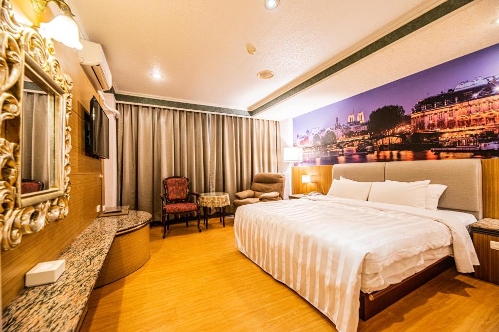 a hotel room with a bed and a television at Wenpin Hotel - Pier 2 in Kaohsiung