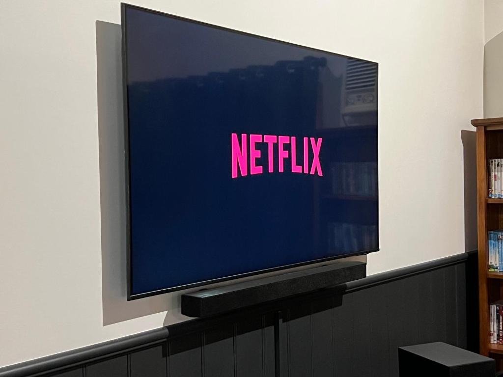 a television screen with the netflix sign on it at The Kingfisher Lodge 111 in Halls Gap