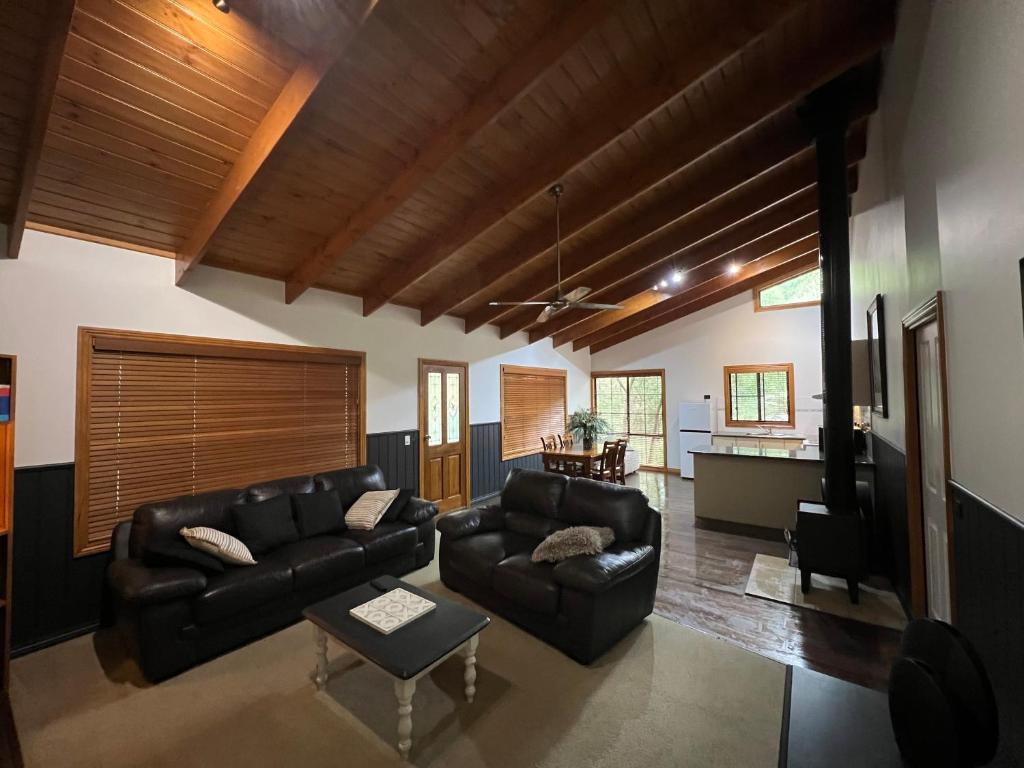 a living room with a couch and a table at The Kingfisher Lodge 111 in Halls Gap
