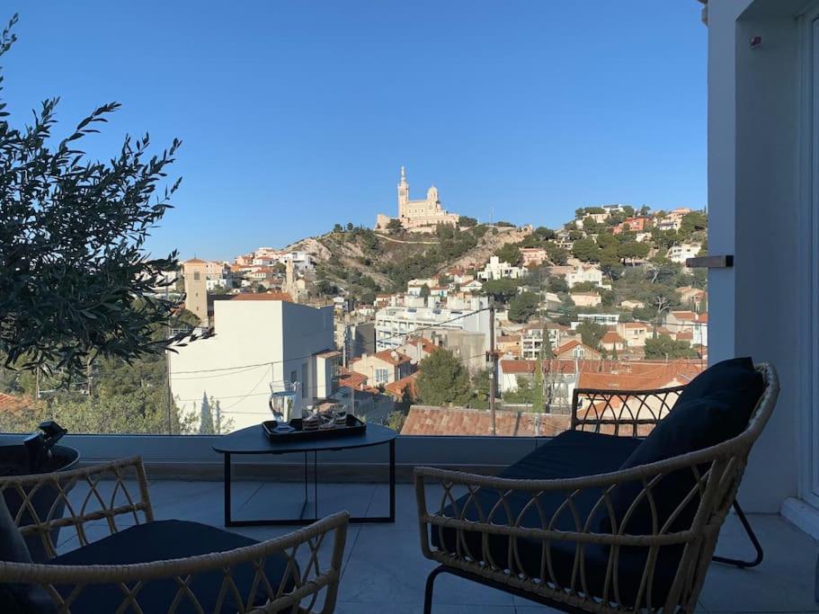 a balcony with two chairs and a table with a view at Les Balcons du Roucas Blanc in Marseille