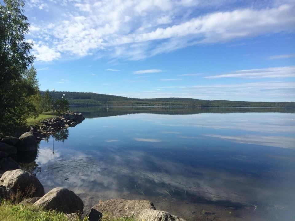 a large body of water with rocks on the shore at Fredsberg Apartments in Sörbygden