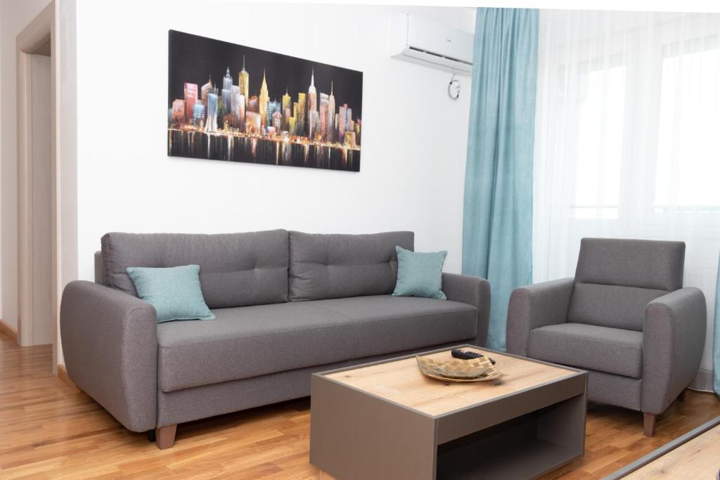 a living room with a couch and two chairs at Millennium Apartment in Bačka Palanka