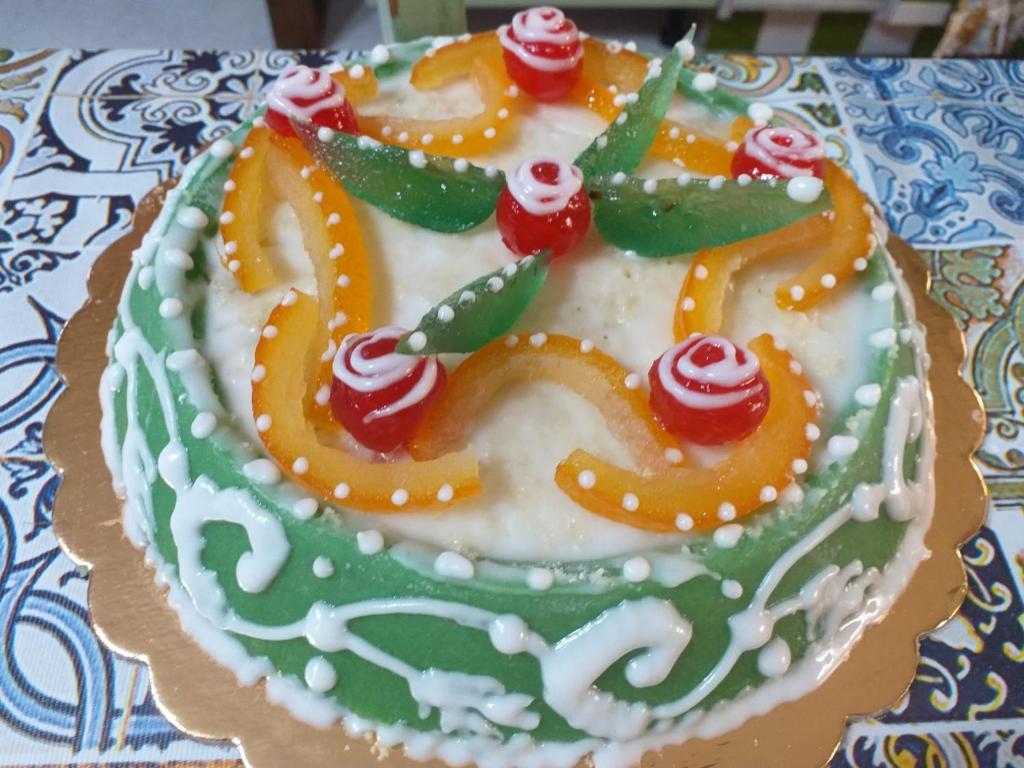 una torta verde e bianca con un serpente sopra. di La Casetta a Palermo