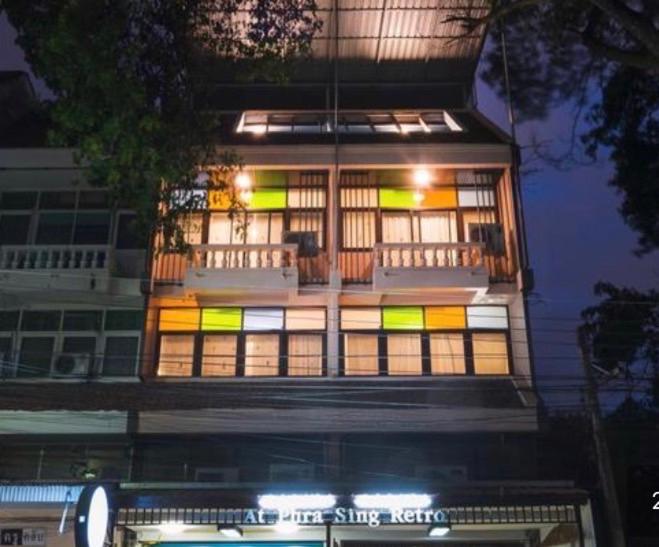 Un edificio alto con molte finestre sopra. di Retro At Phra Sing Guest House a Chiang Mai
