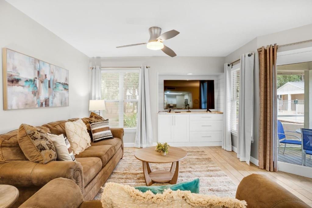 a living room with a couch and a table at Hidden Dunes Beach Cottage 208- Dune Our Thing in Destin