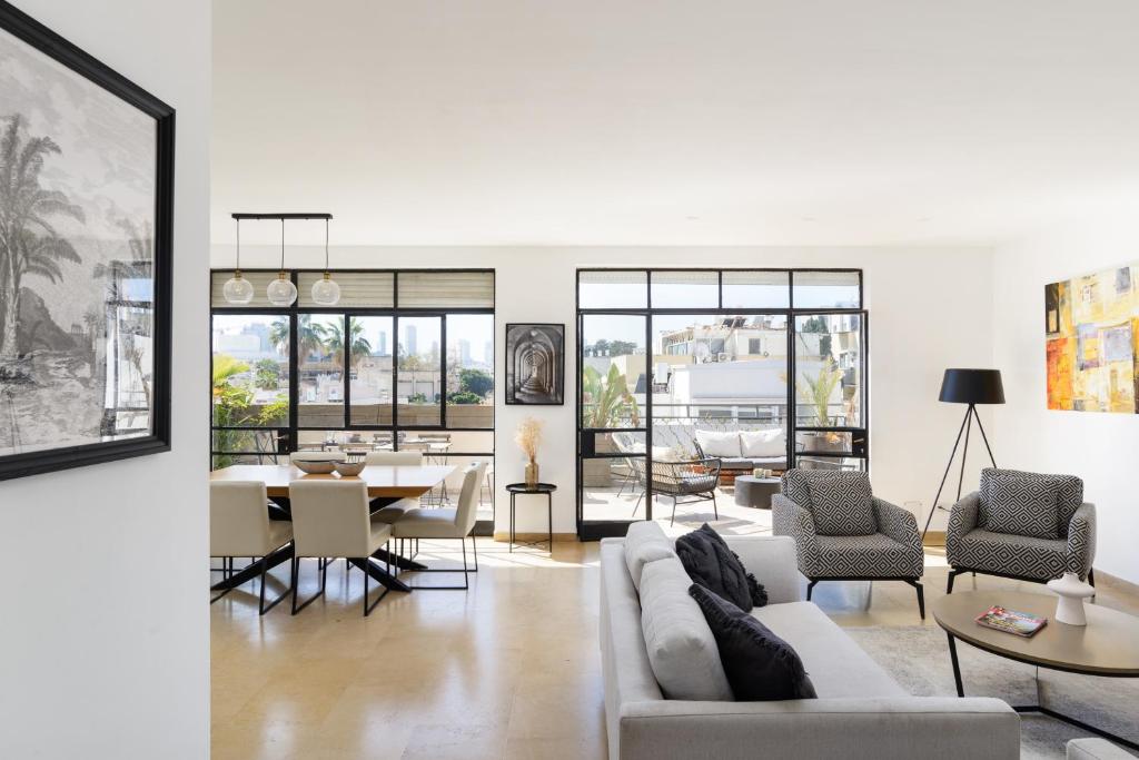 a living room with a couch and a table at Amazing Duplex with 2 Terraces in City Center by FeelHome in Tel Aviv