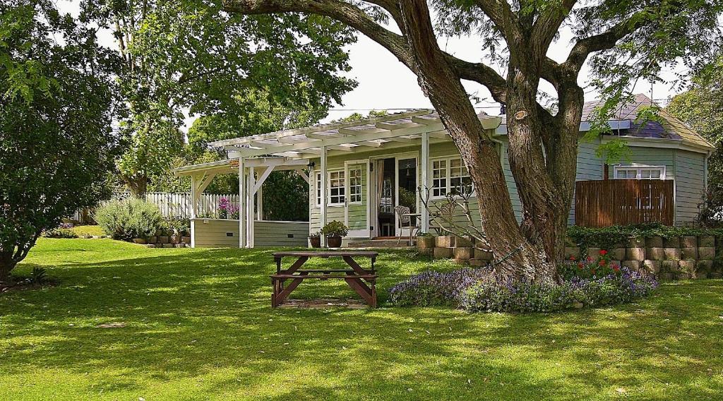 a house with a picnic table in the yard at Deja Vu Cottage in Sedgefield