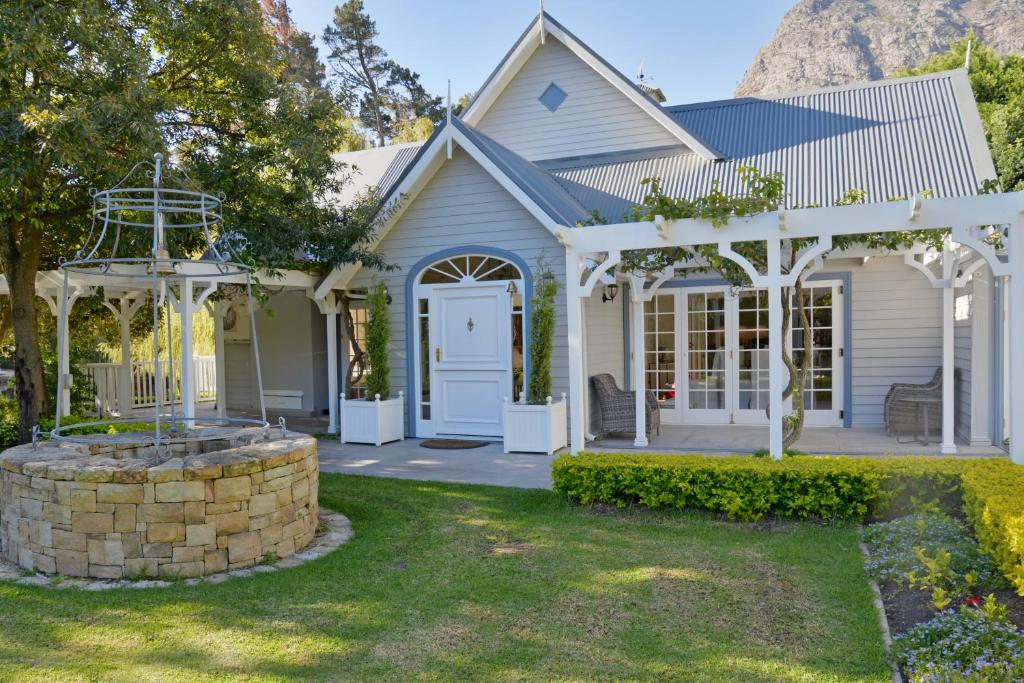 a white house with a gazebo at Farm Lorraine Lake Cottage, Loft Cottage and Garden Cottage in Franschhoek