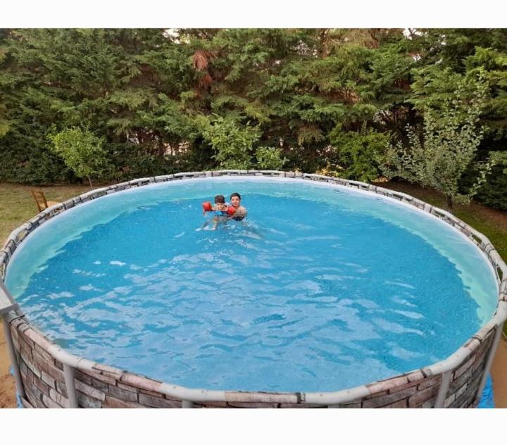CodaruinaにあるCasa Vacanze con Piscina Esclusiva La Ciaccia Valledoriaの2名が大きなプールで泳いでいます。