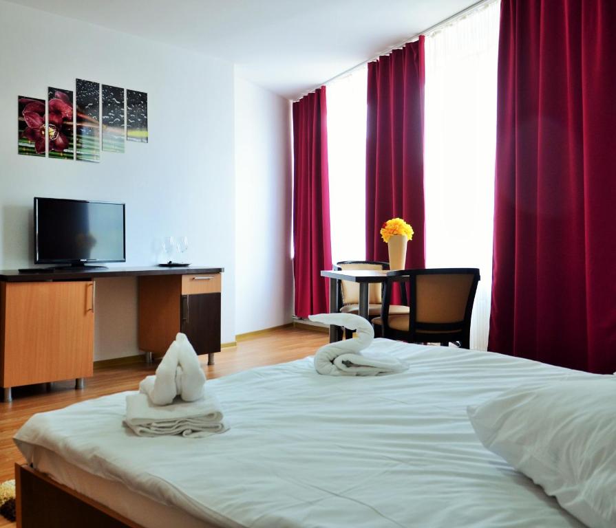 Postel nebo postele na pokoji v ubytování ApartHotel Zorilor