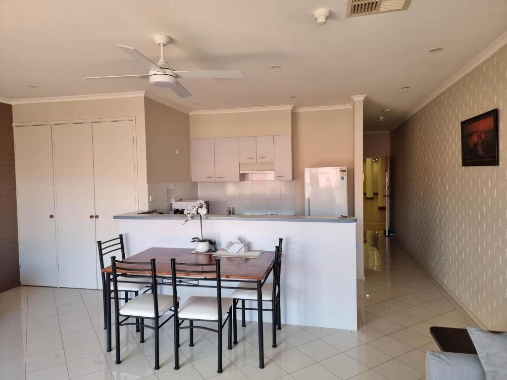 a kitchen with a table and chairs in a room at Tuggeranong Short Stay #09 Sleeps 4 in Tuggeranong