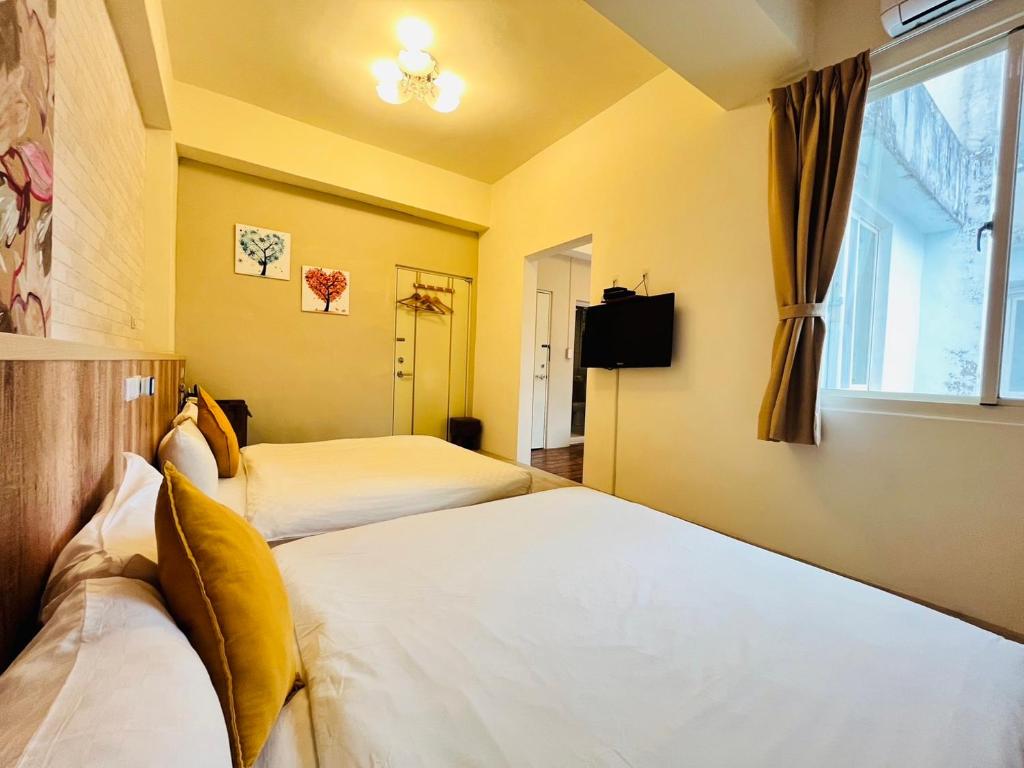 Postel nebo postele na pokoji v ubytování Sweet B&B 幸福微甜民宿