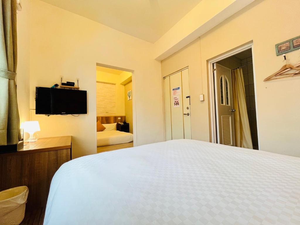 Postel nebo postele na pokoji v ubytování Sweet B&B 幸福微甜民宿