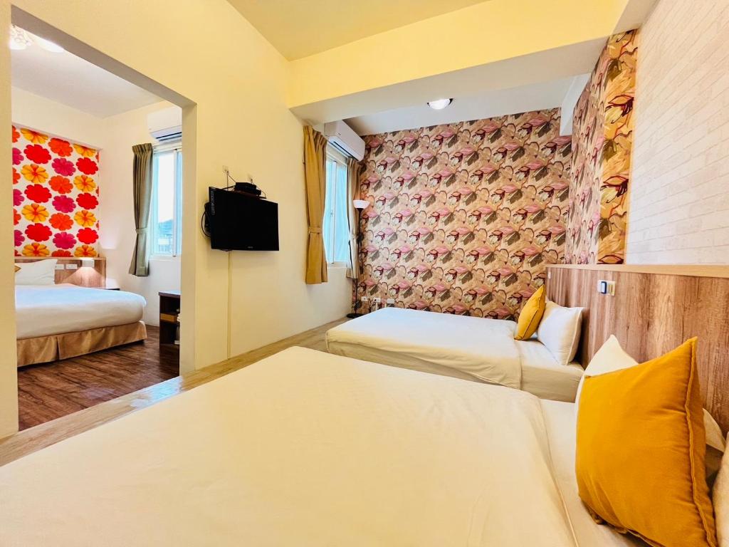 Postel nebo postele na pokoji v ubytování Sweet B&B 幸福微甜民宿