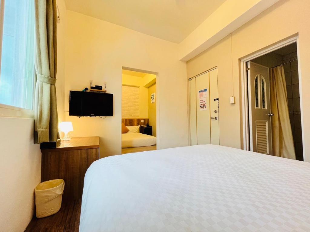 Postel nebo postele na pokoji v ubytování Sweet B&B 幸福微甜民宿