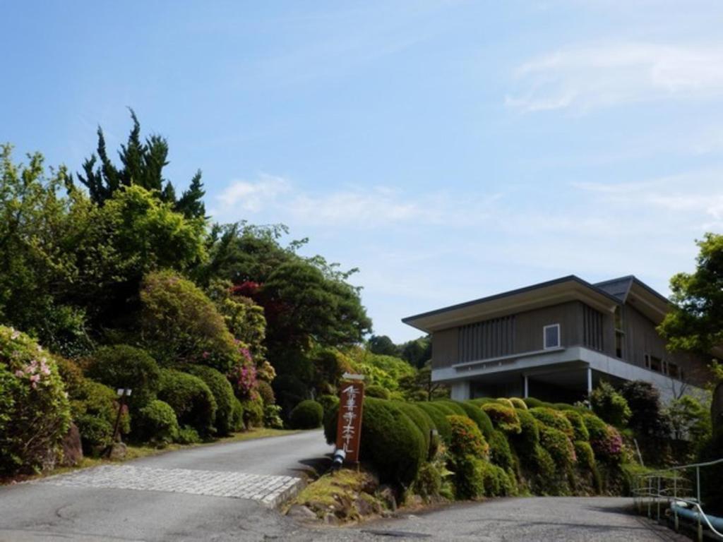a house on a hill with a driveway at Breezbay Shuzenji Hotel in Izu
