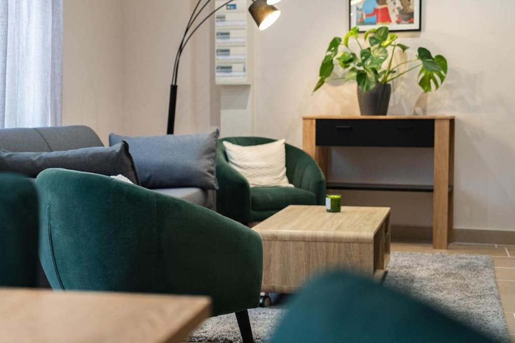 a living room with a couch and chairs and a table at La Ferme de Bacchus in Hautvillers