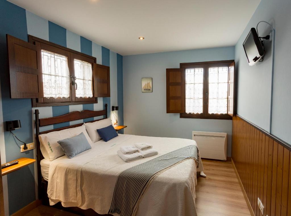 Postel nebo postele na pokoji v ubytování Apartamentos Rurales Villa del Sain Cudillero