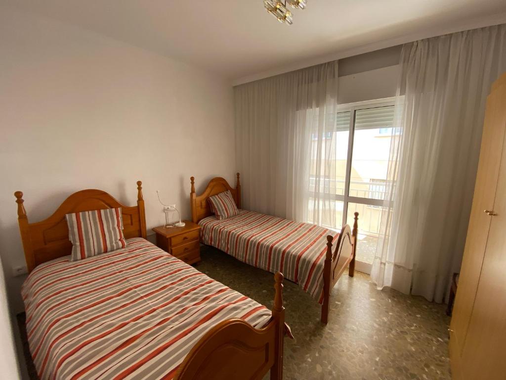 Posteľ alebo postele v izbe v ubytovaní Apartamentos "Un Rico Domingo", Parking solo planta baja