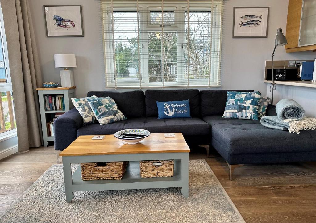 a living room with a couch and a coffee table at Driftwood Lodge in Salcombe
