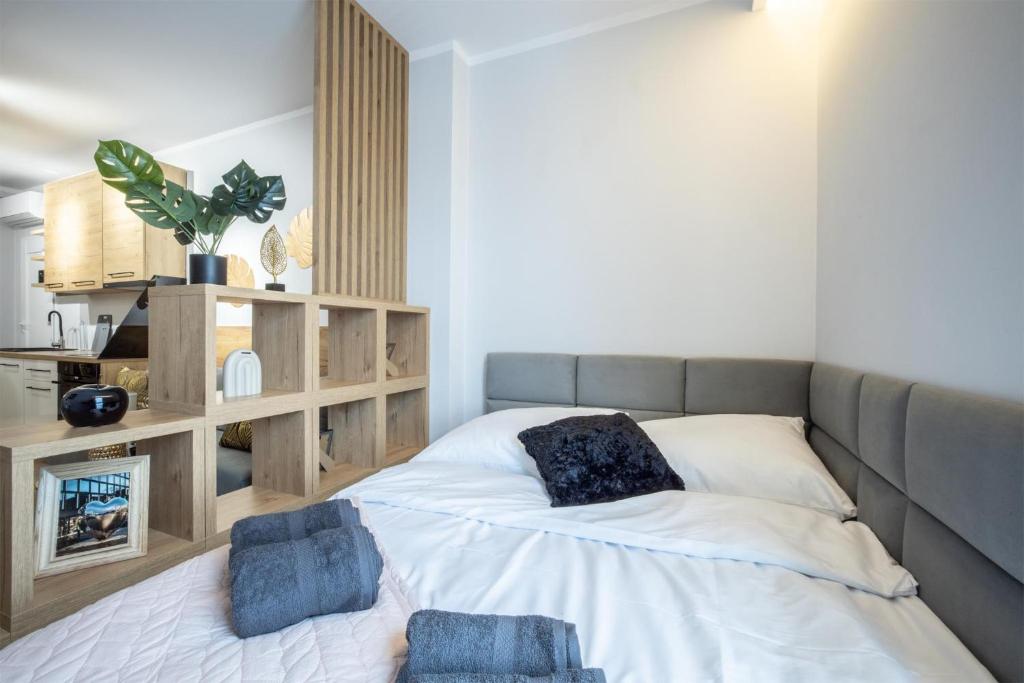 um quarto com uma cama com duas almofadas em WiguryTower Apartaments 66' em Lódź