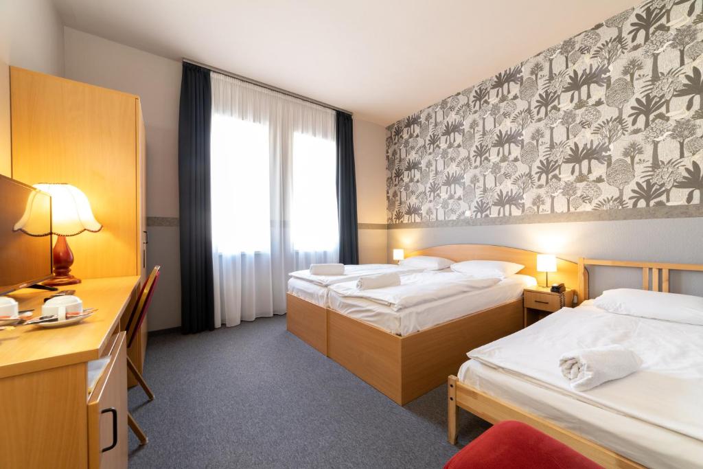 Posteľ alebo postele v izbe v ubytovaní Gartner Hotel