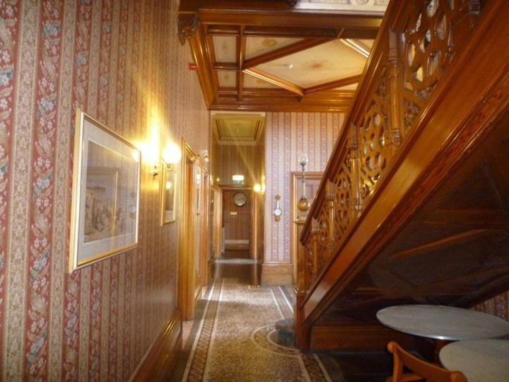 a hallway with a wooden staircase in a house at Purbeck House Hotel & Louisa Lodge in Swanage