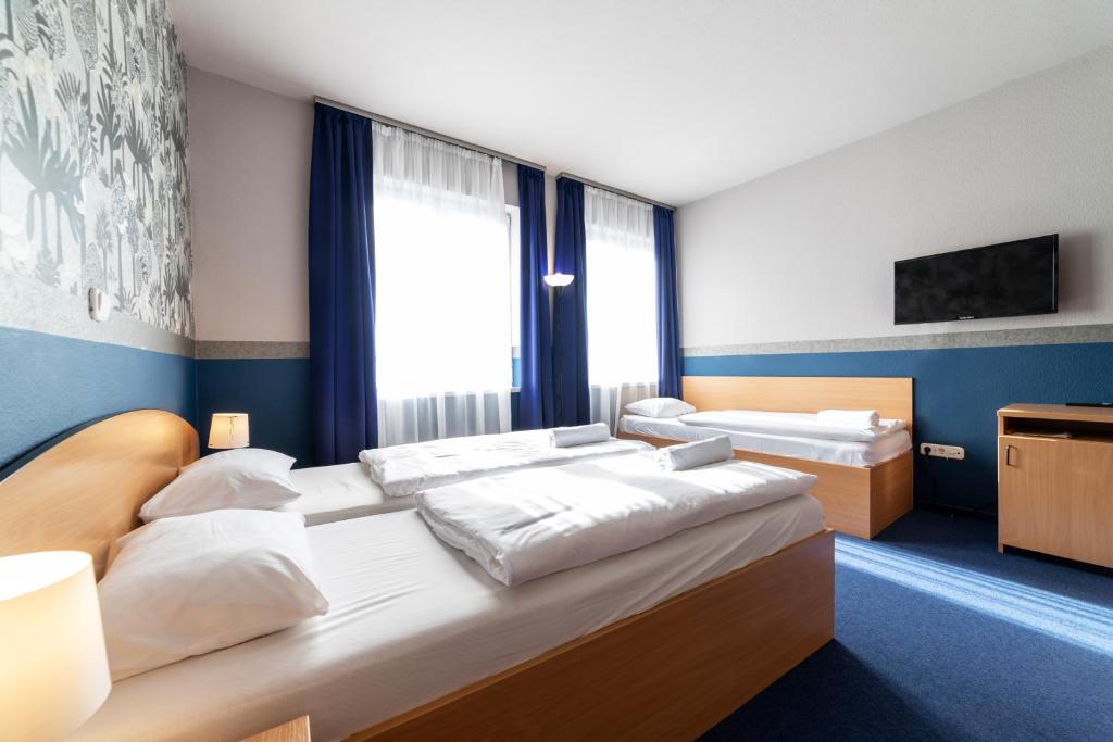 Posteľ alebo postele v izbe v ubytovaní Gartner Hotel