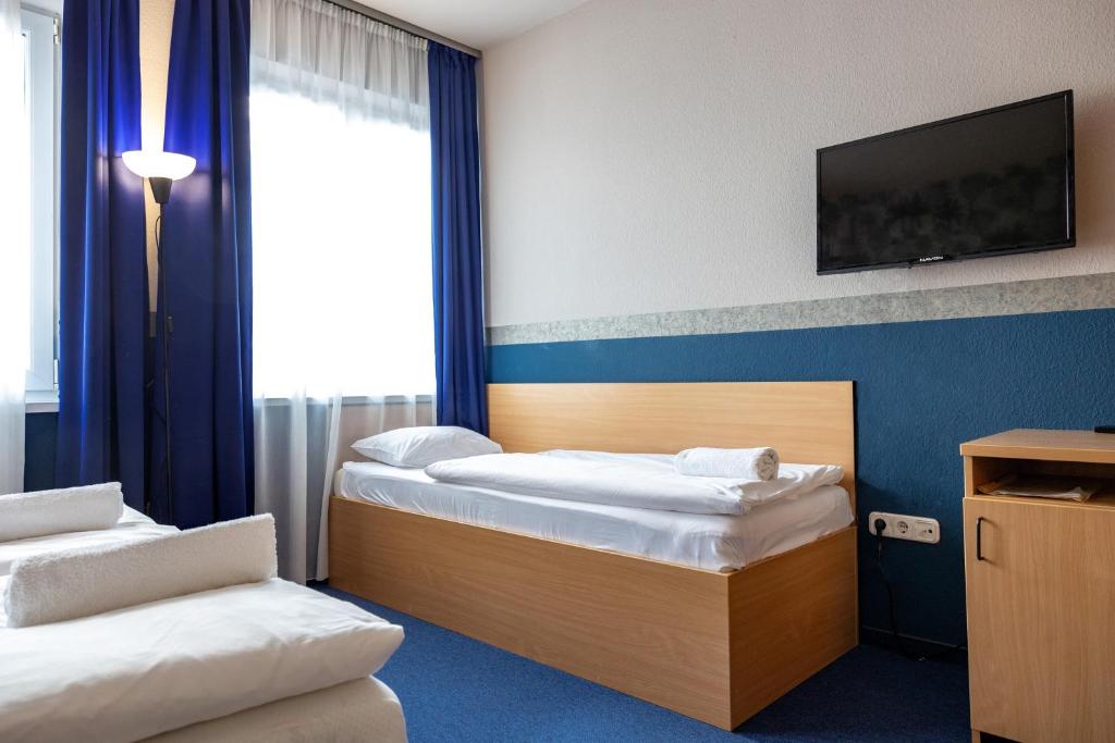 Posteľ alebo postele v izbe v ubytovaní Gartner Hotel