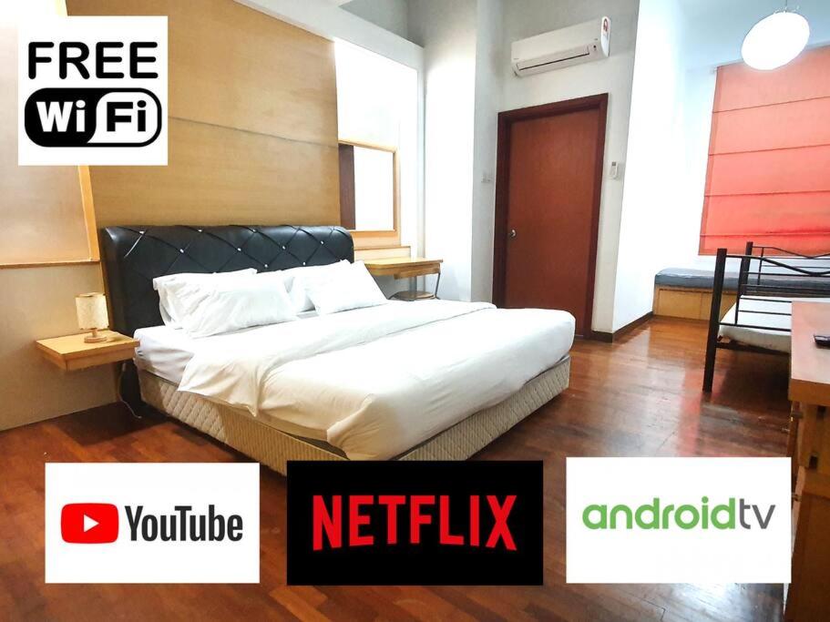 a bedroom with a bed and a sign that reads netflix at [HERITAGE 4] HOMESTAY Studio 4Pax, FREE WIFI in Seri Kembangan