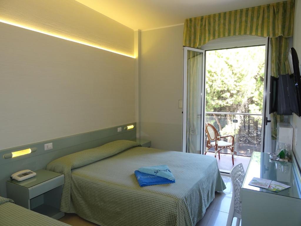 a hotel room with a bed and a balcony at Hotel Garden in Cervia