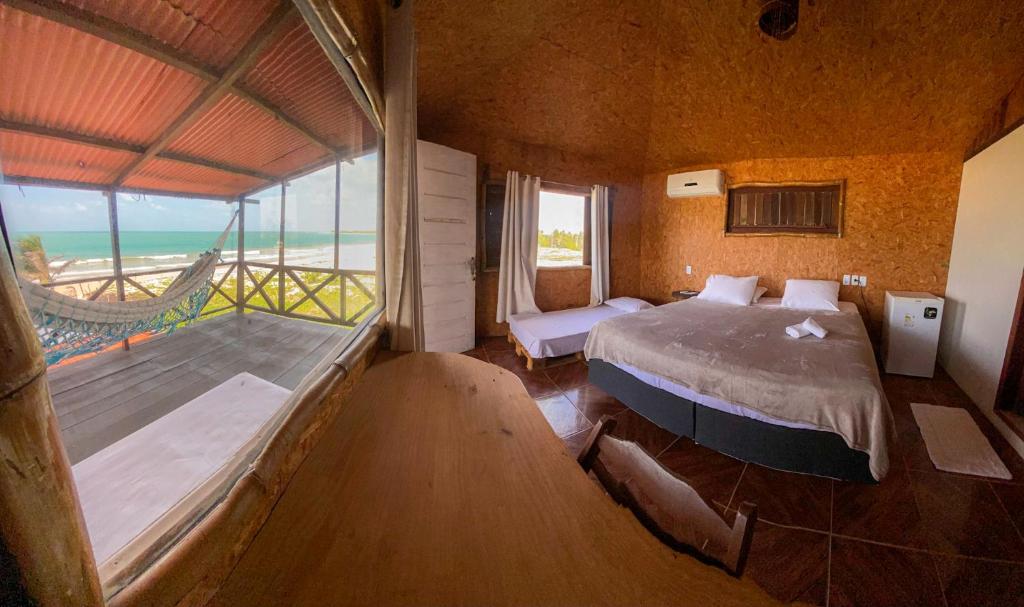 a bedroom with a bed and a view of the ocean at Casa Janjão in Icaraí