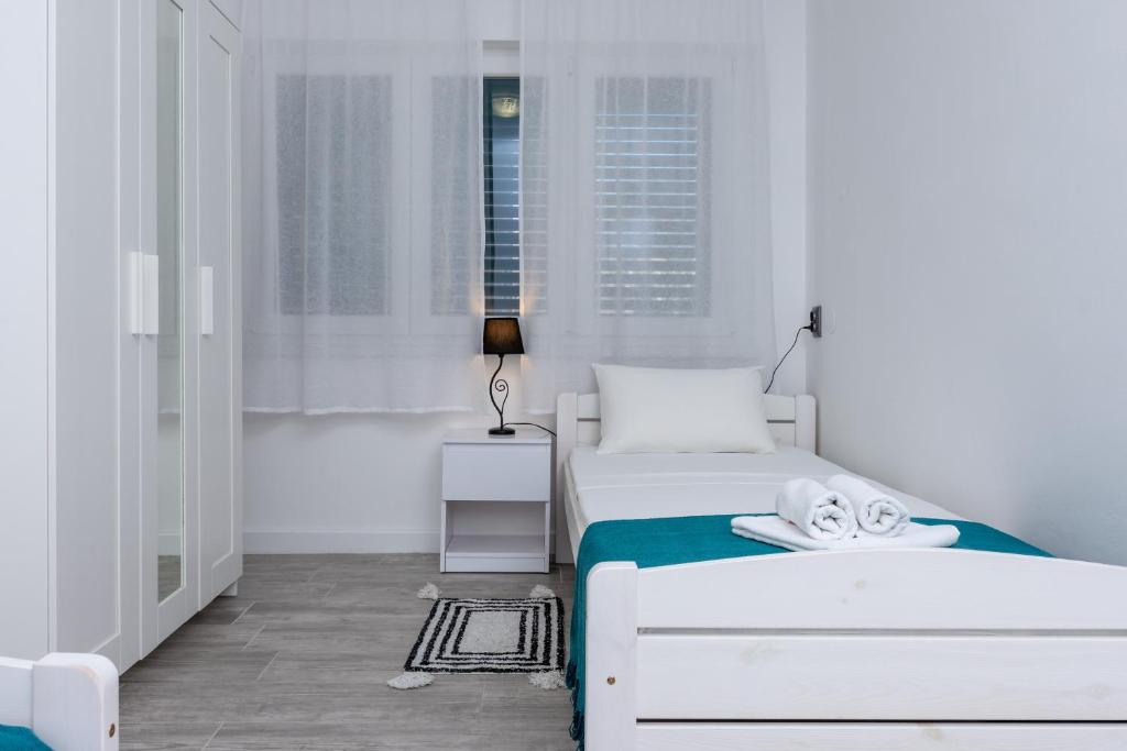 Posteľ alebo postele v izbe v ubytovaní Blue Mile Apartman Split