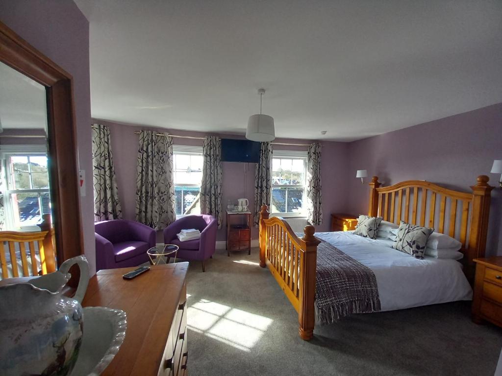 a bedroom with a bed and a living room at Bryncelyn Guesthouse in Llanwrtyd Wells