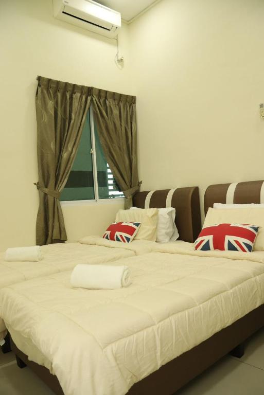 two large beds in a room with a window at Ipoh Tambun Lost World Le Greens in Ipoh