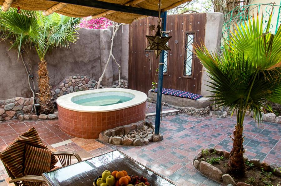 a jacuzzi tub in a patio with a table and fruits at Villa Boheme & Atelier Boheme in Dahab
